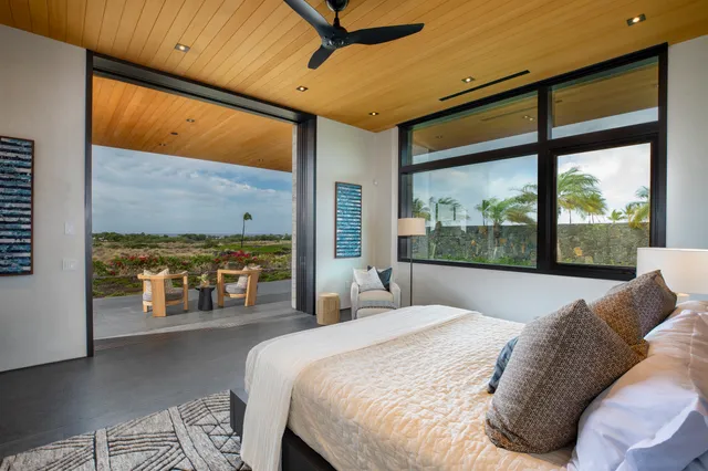 a bedroom with a large bed and a balcony view