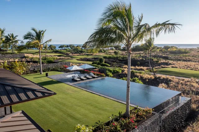 a view of a swimming pool with a lawn chairs and swimming pool