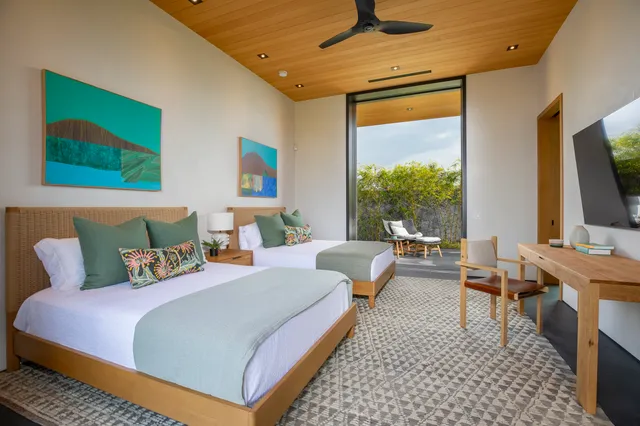 a bedroom with furniture and a flat screen tv