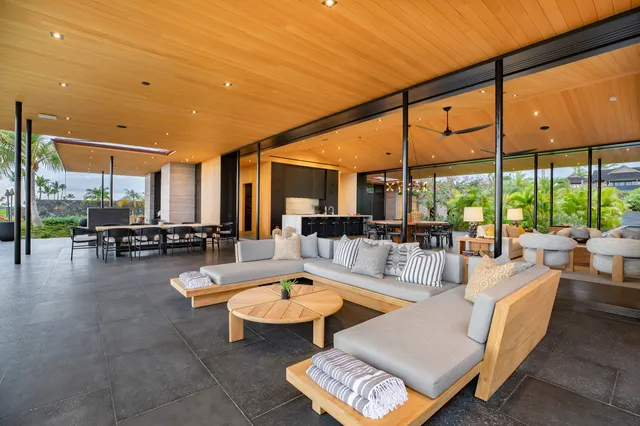 a living room with patio furniture and a large window