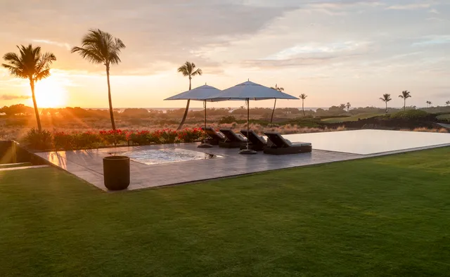 a view of a lake with lawn chairs