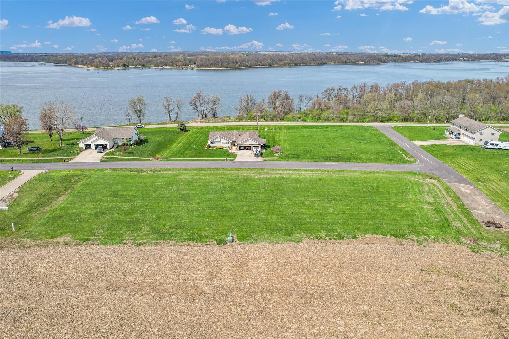 18041 Lakeview Drive Weldon, IL 61882 - Photo 17 of 17 a view of a lake with a big yard and a large mountain view