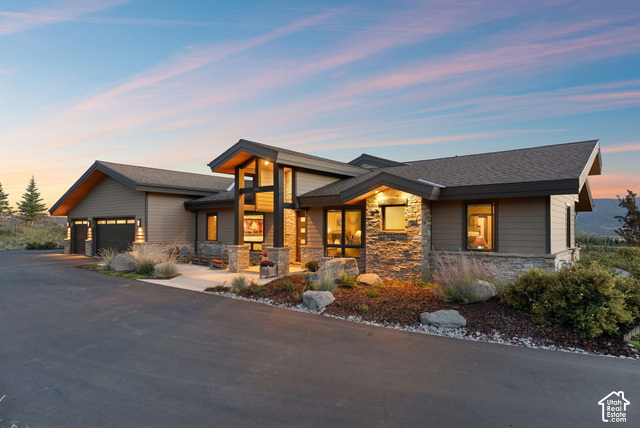 1130 Pace Road Park City, UT 84098 - Photo 71 of 73 Contemporary architectural design with multiple rooflines, stone and siding exterior, large windows, and an attached two-car garage