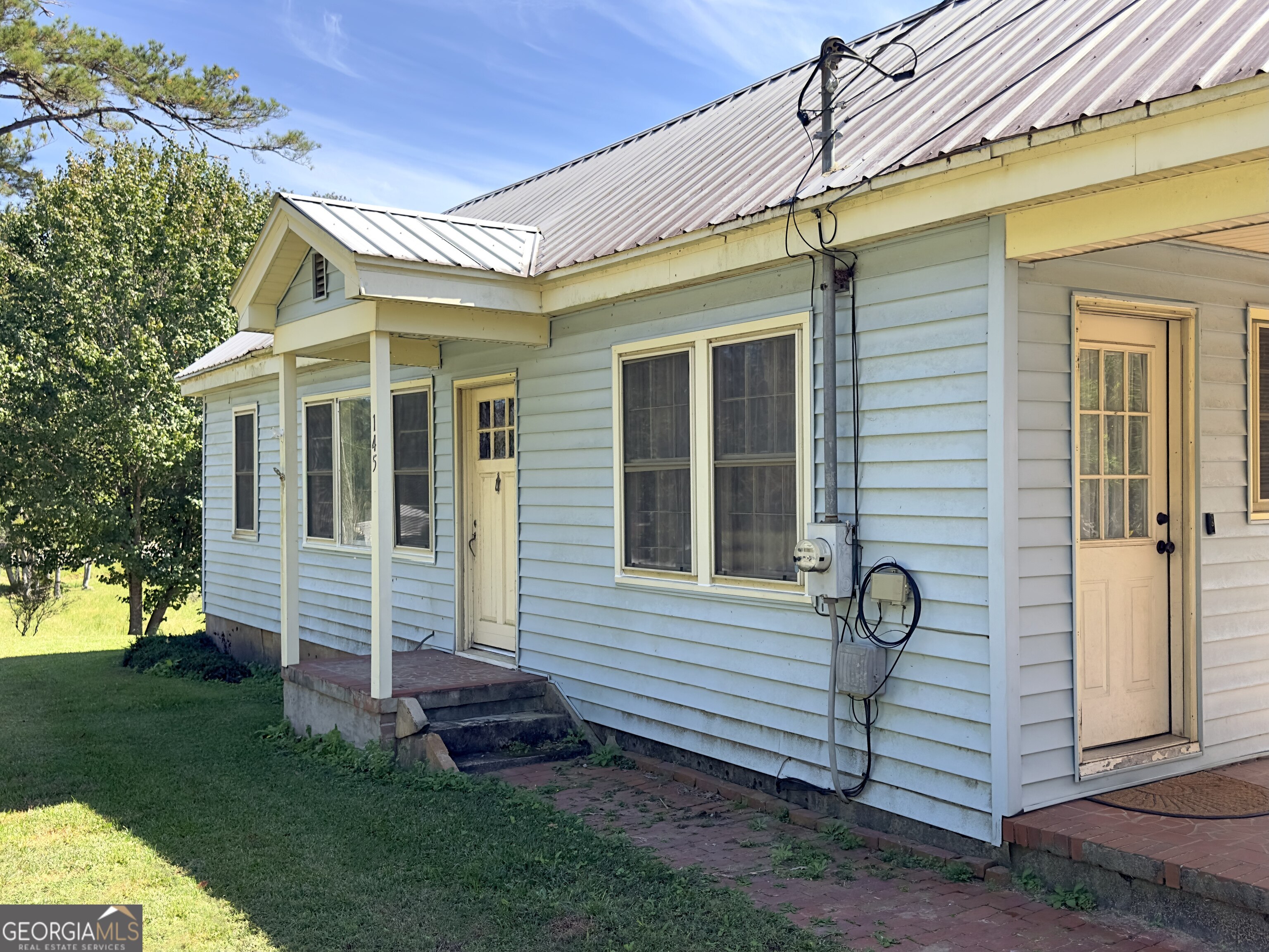 145 Apple Road Thomaston, GA 30286 - Photo 16 of 43 a front view of a house with a garden