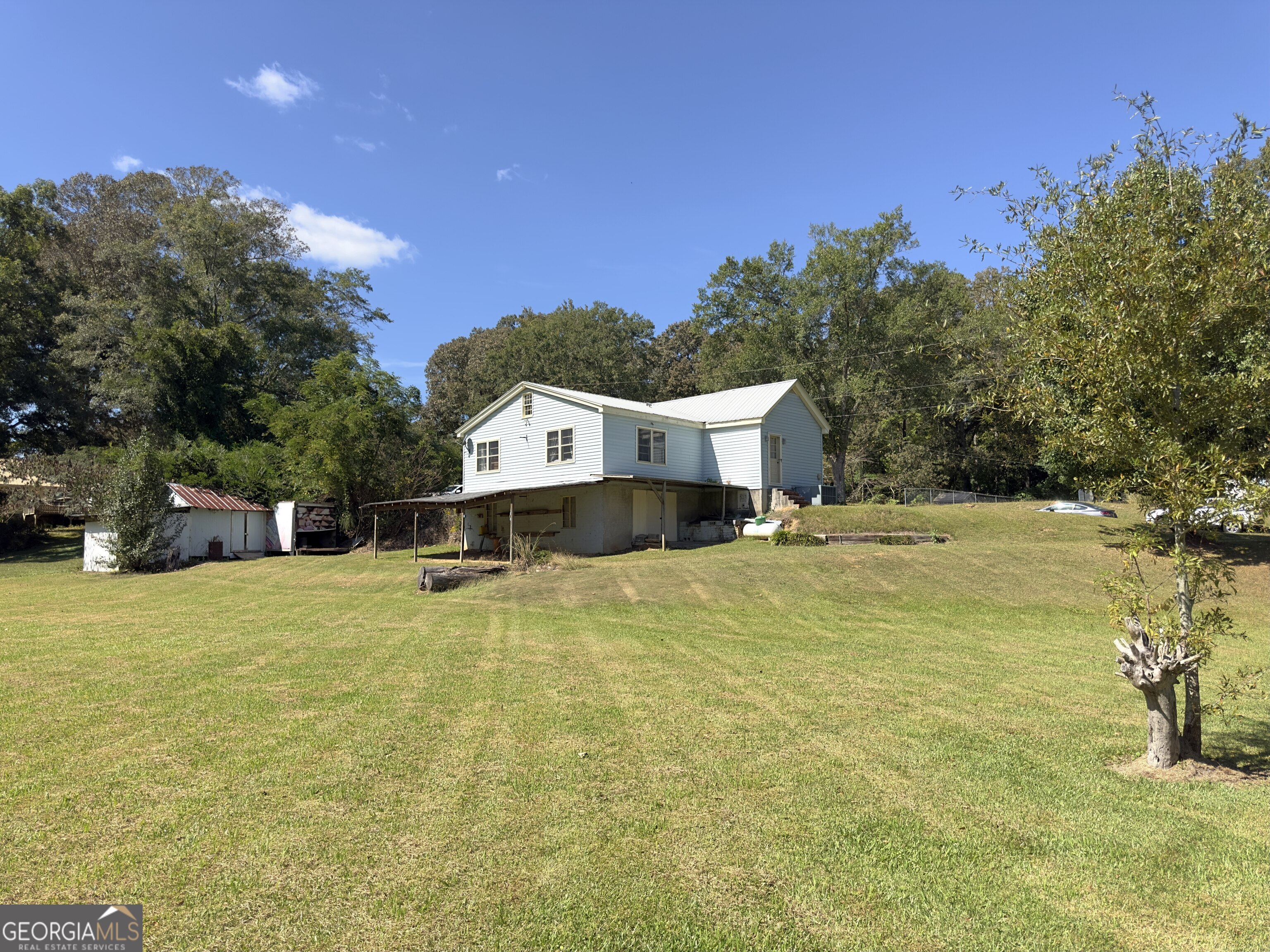 145 Apple Road Thomaston, GA 30286 - Photo 22 of 43 a swimming pool with trees in the background
