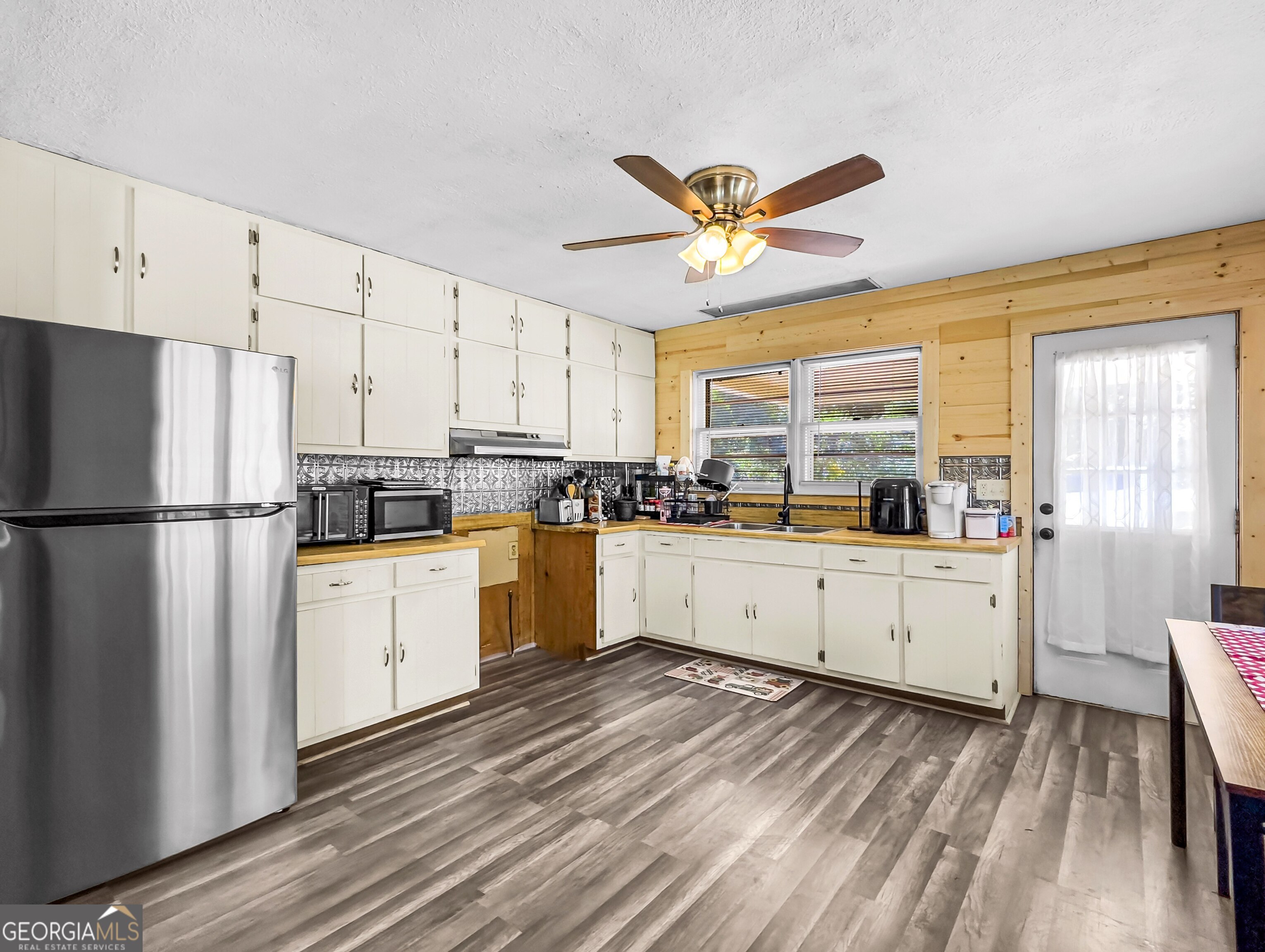 145 Apple Road Thomaston, GA 30286 - Photo 24 of 43 a kitchen with white cabinets and white appliances