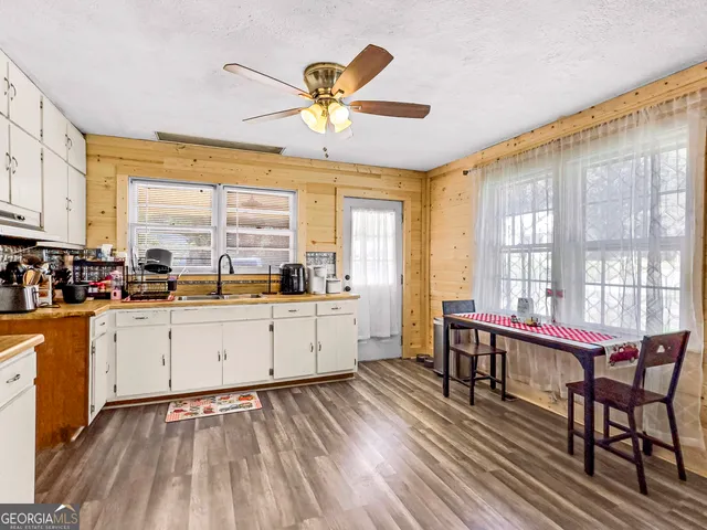 a large white kitchen with a large window
