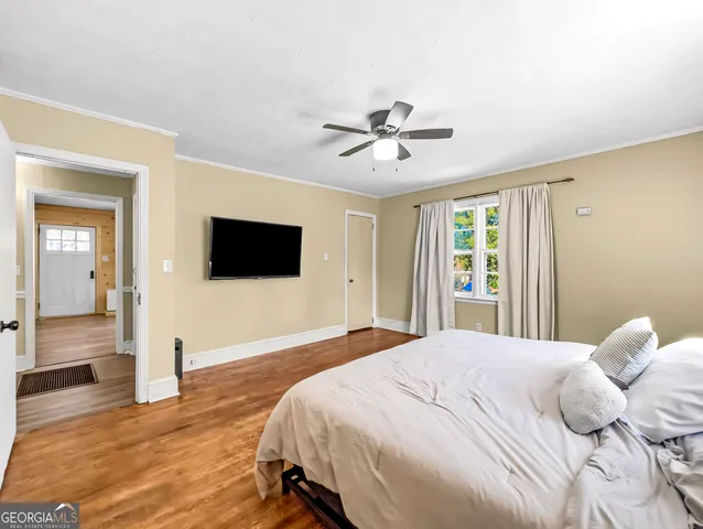 a bedroom with a bed and a flat screen tv