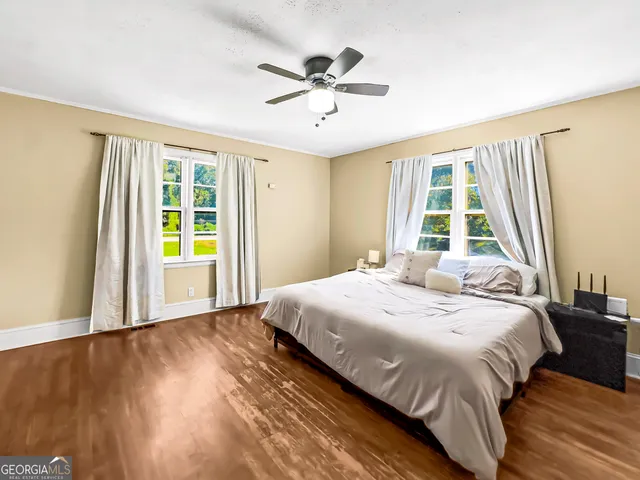 a bedroom with a bed and window
