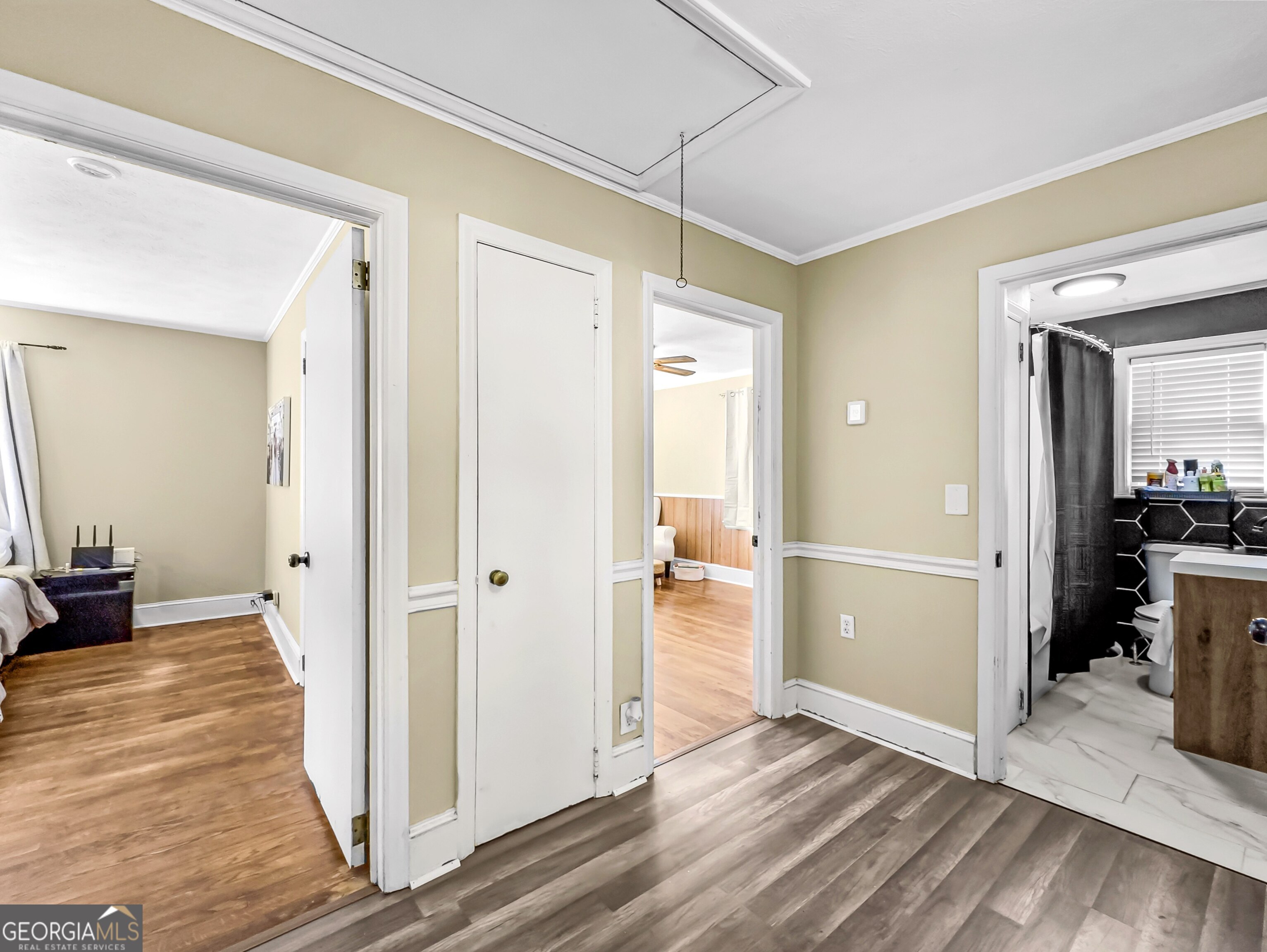 145 Apple Road Thomaston, GA 30286 - Photo 34 of 43 a view of a hallway with wooden floor and dining room view