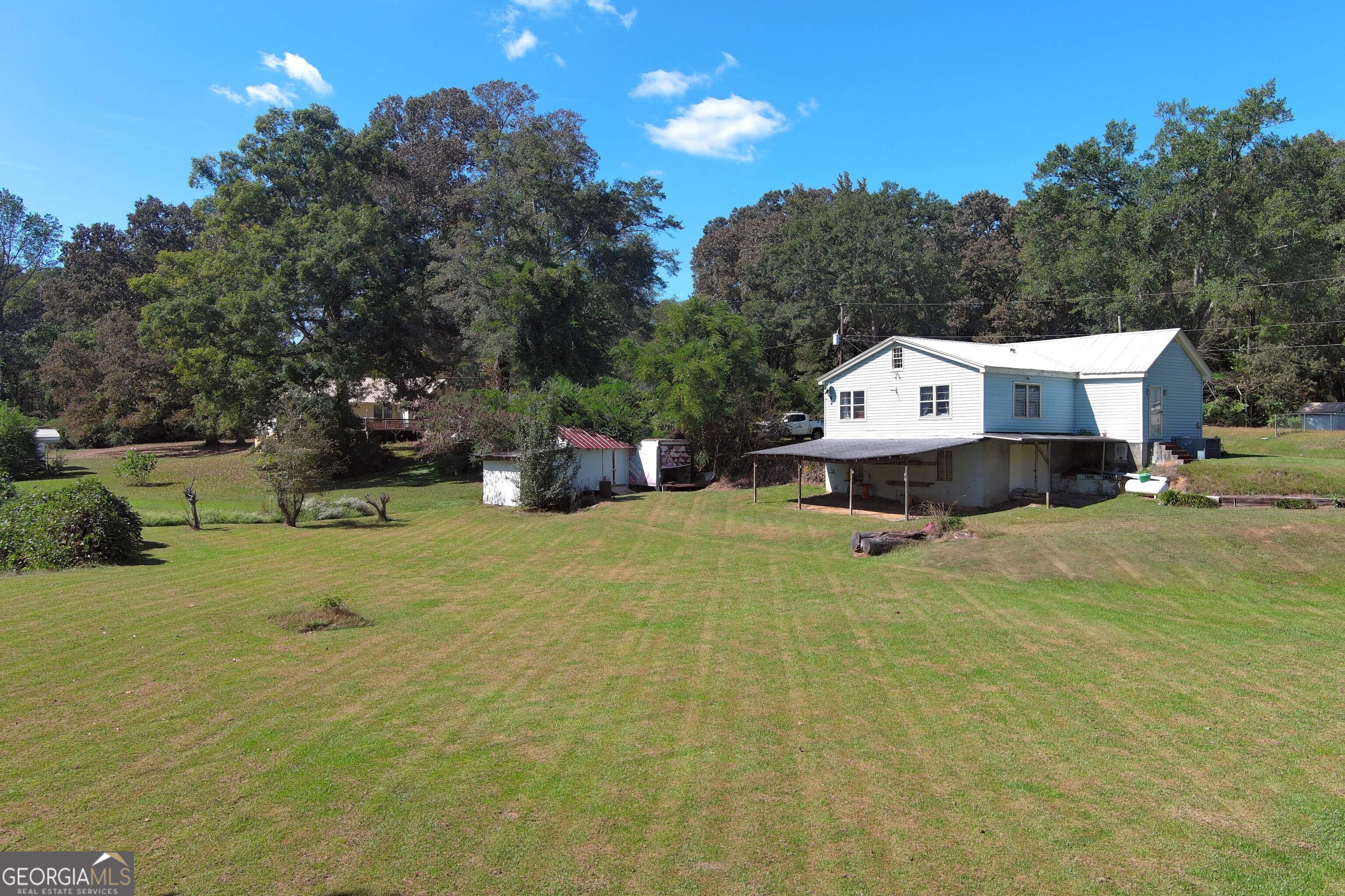 145 Apple Road Thomaston, GA 30286 - Photo 7 of 43 a view of swimming pool with seating area and trees around