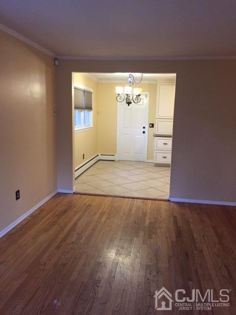 65 Tower Road Edison, NJ 08820 - Photo 11 of 11 an empty room with wooden floor and windows