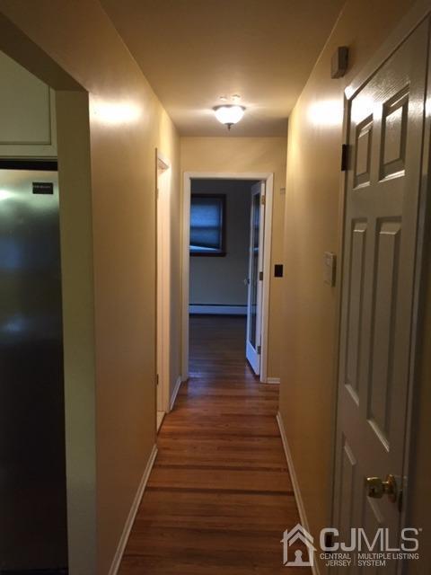 65 Tower Road Edison, NJ 08820 - Photo 3 of 11 a view of a hallway with wooden floor