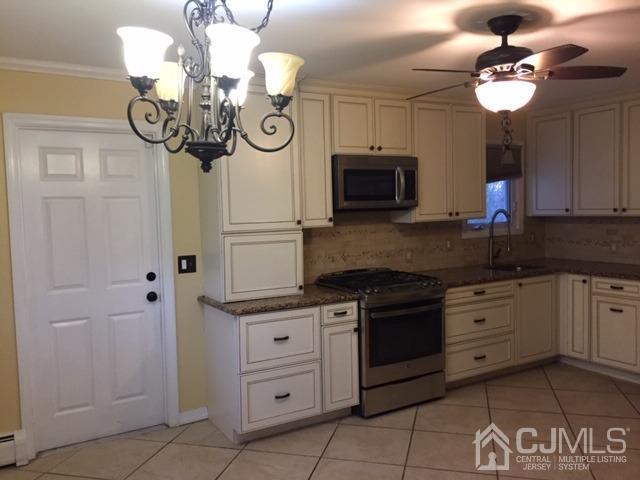 65 Tower Road Edison, NJ 08820 - Photo 10 of 11 a kitchen with a stove oven and a sink