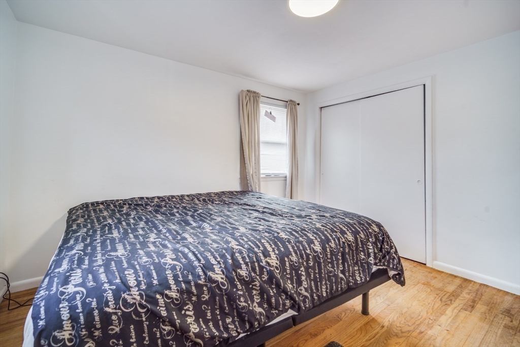 91 Arcadia Boulevard Springfield, MA 01118 - Photo 18 of 34 a bedroom with a bed and a window