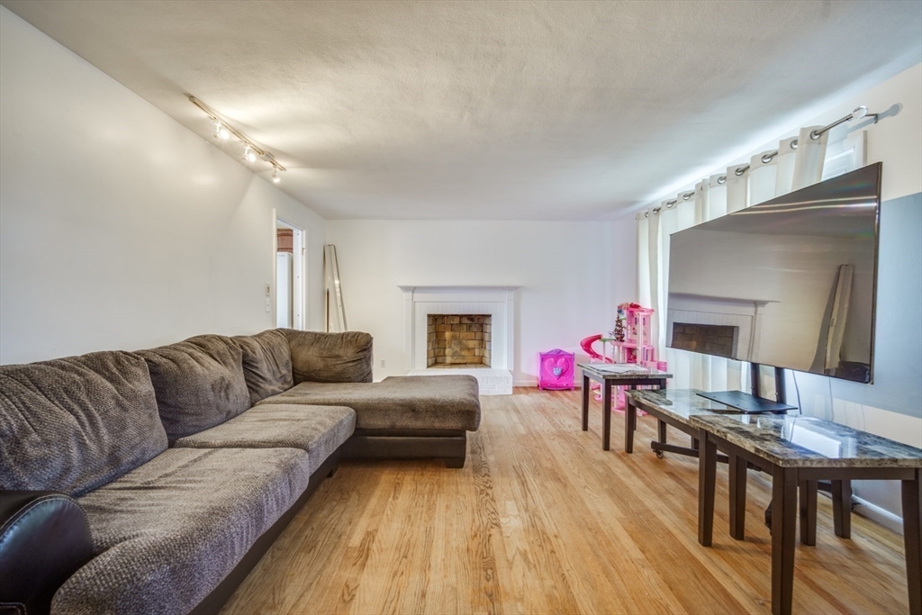 91 Arcadia Boulevard Springfield, MA 01118 - Photo 7 of 34 a living room with furniture and a wooden floor