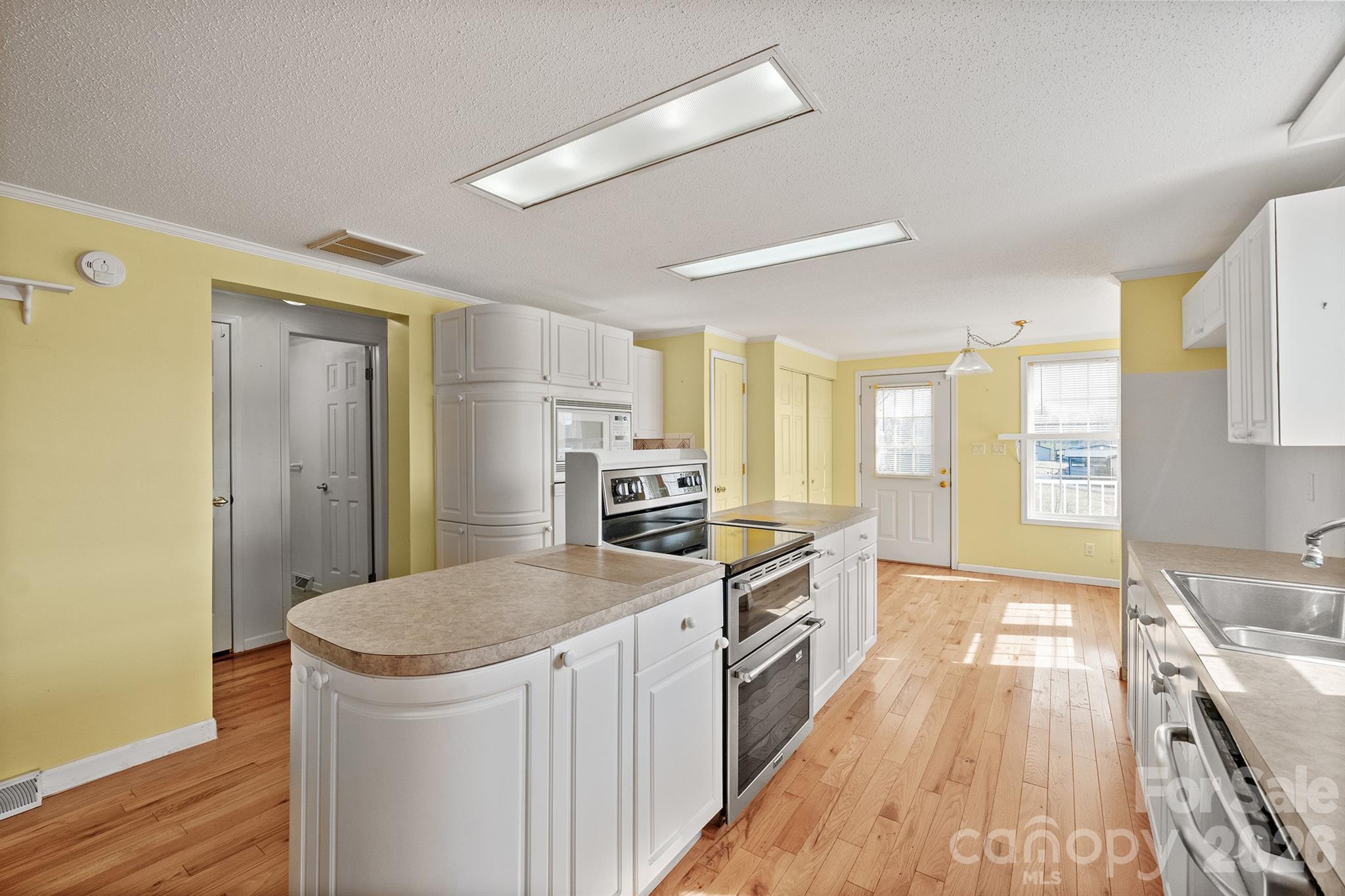 2991 Sam Houser Road Vale, NC 28168 - Photo 13 of 48 a kitchen with granite countertop a sink stove and refrigerator