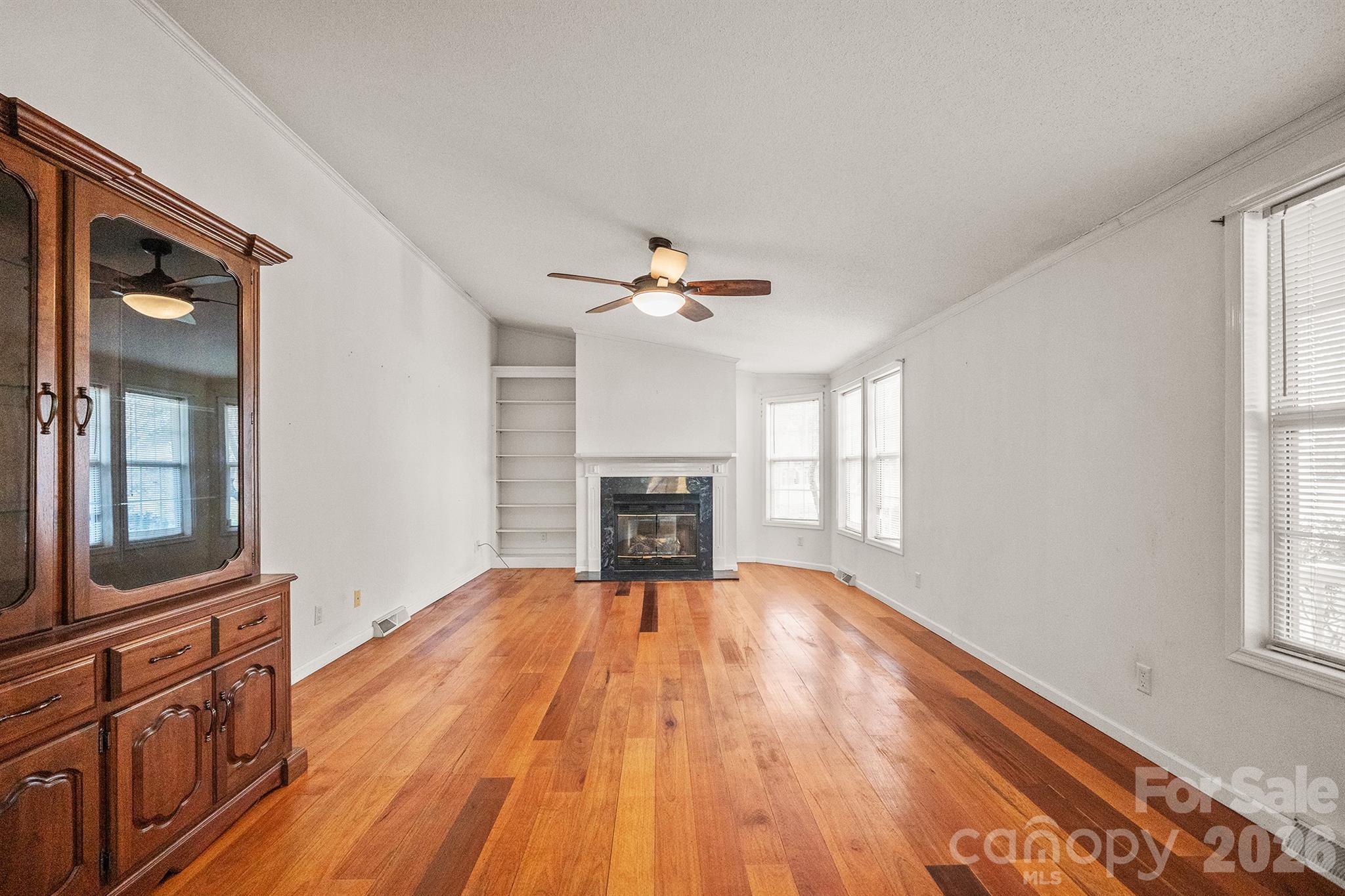 2991 Sam Houser Road Vale, NC 28168 - Photo 15 of 48 a view of a livingroom with a fireplace wooden floor and windows