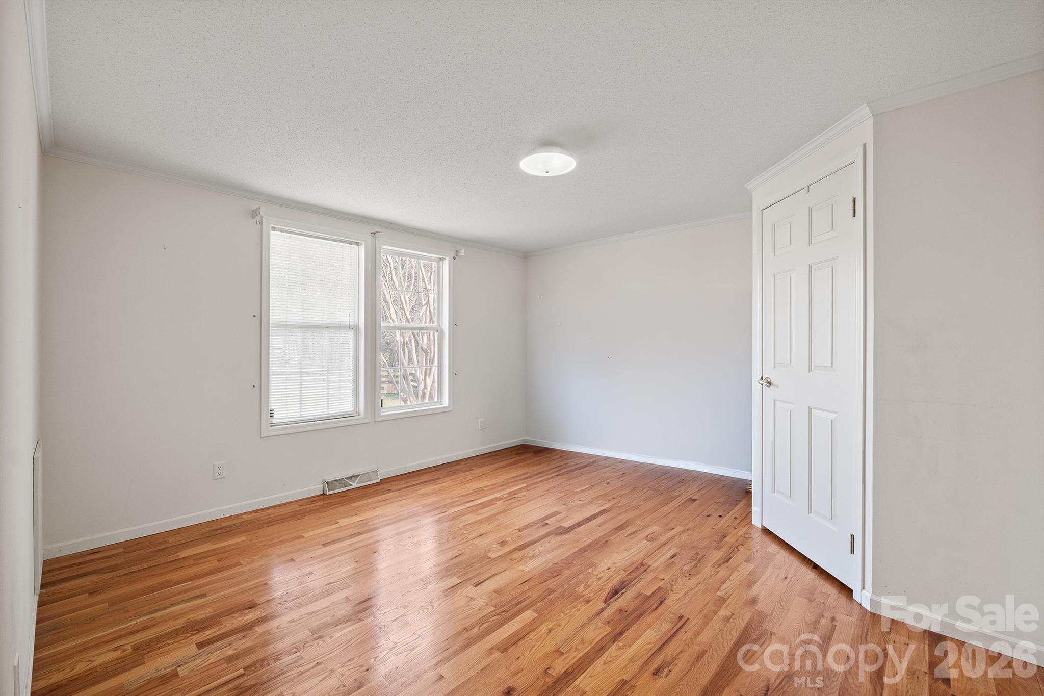 2991 Sam Houser Road Vale, NC 28168 - Photo 18 of 48 an empty room with wooden floor and windows