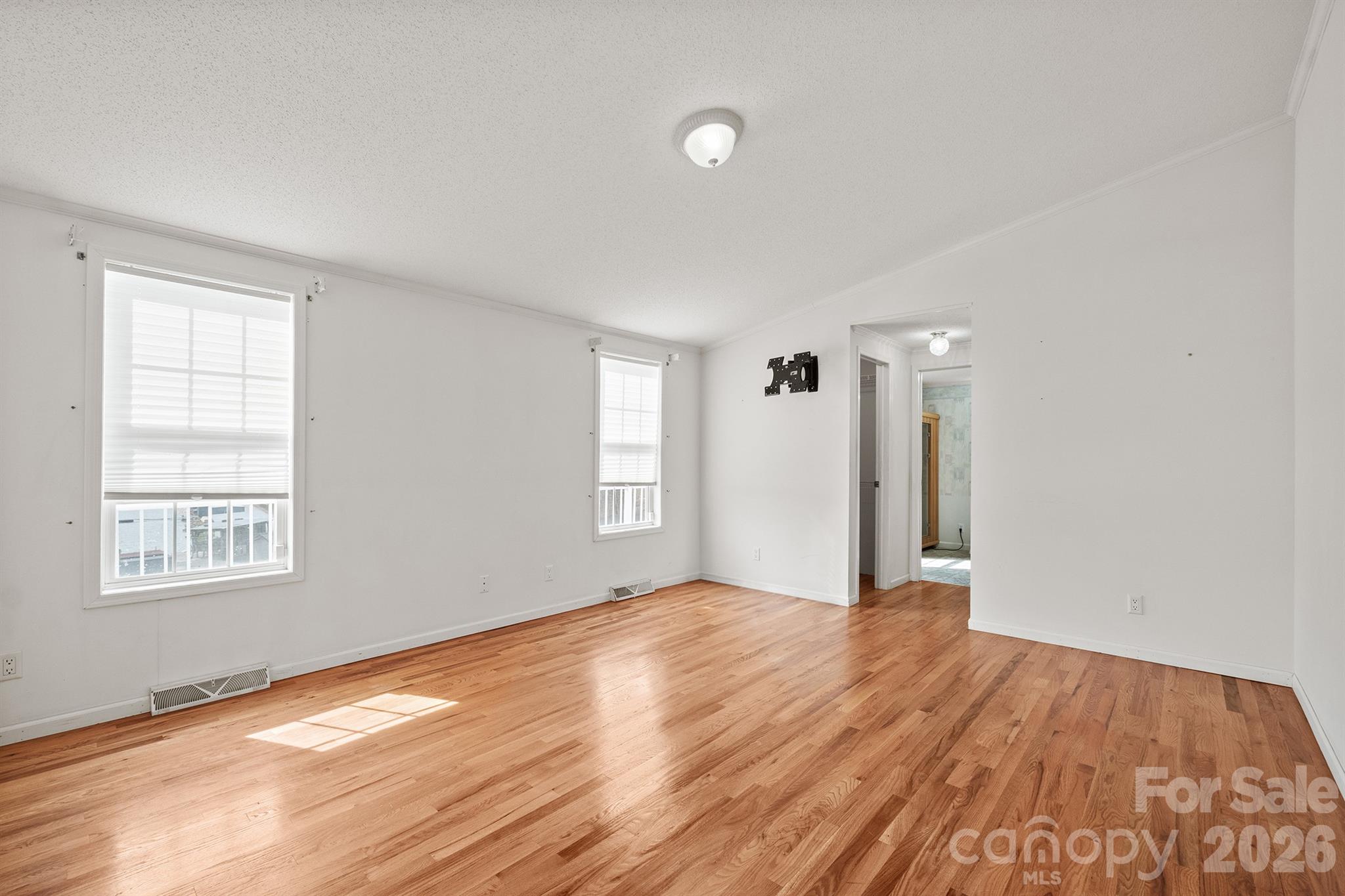 2991 Sam Houser Road Vale, NC 28168 - Photo 21 of 48 a view of an empty room with wooden floor and a window