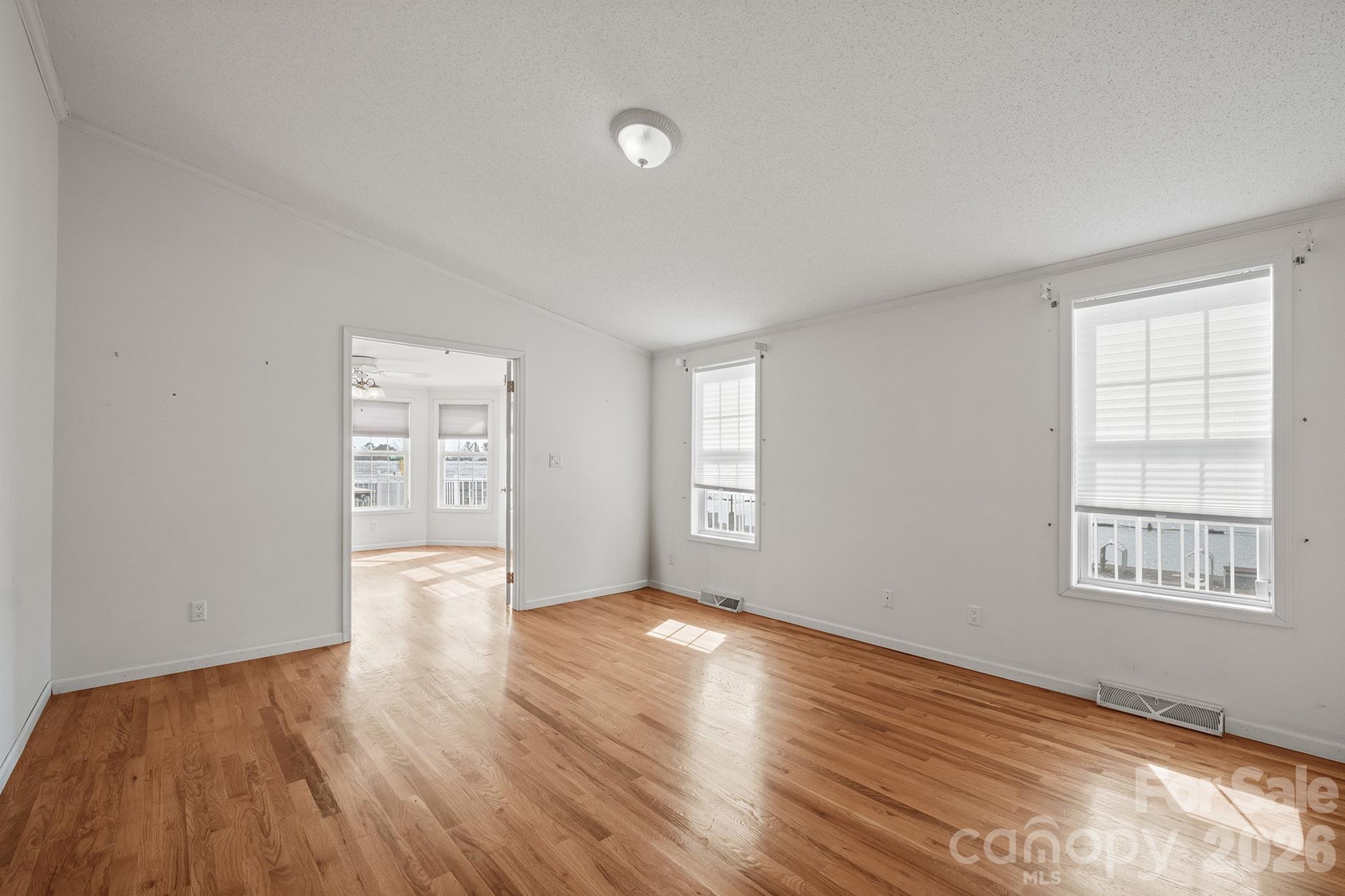 2991 Sam Houser Road Vale, NC 28168 - Photo 22 of 48 a view of an empty room with wooden floor and a window