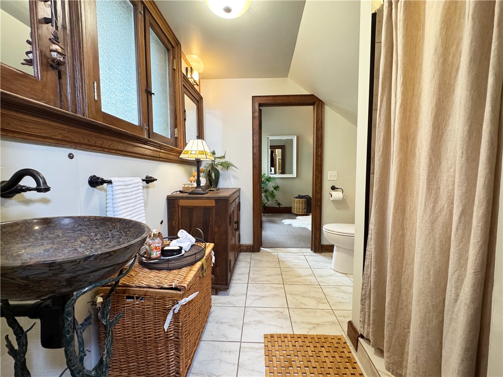 106 Argyle Street Rochester, NY 14607 - Photo 16 of 50 The bathroom is updated with an easy and convenient walk in shower and unique pedestal sink.
