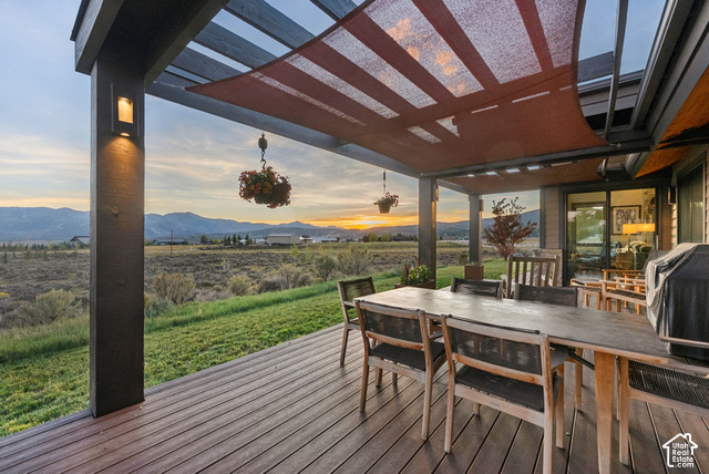 1130 Pace Road Park City, UT 84098 - Photo 30 of 73 Expansive outdoor living area featuring a covered deck, wood-finish composite decking, and a red shade canopy