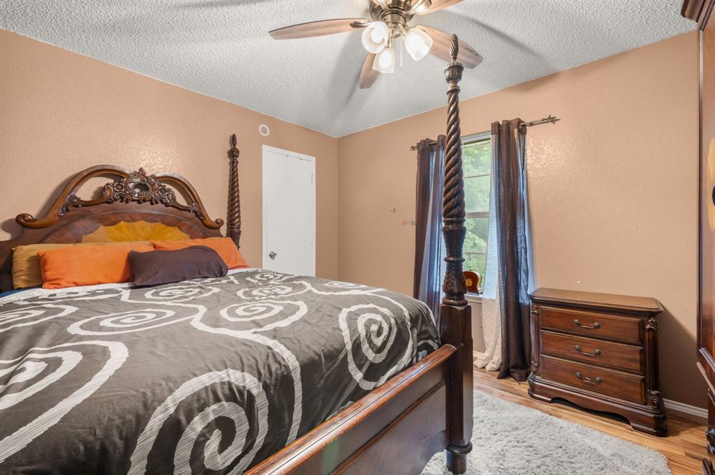 916 Danforth Place Arlington, TX 76017 - Photo 24 of 30 Warmly painted interior with a ceiling fan light fixture and wood-finish flooring