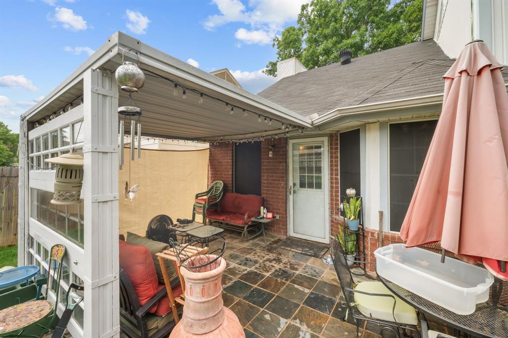 916 Danforth Place Arlington, TX 76017 - Photo 30 of 30 Covered patio featuring a slate tile floor and string lighting