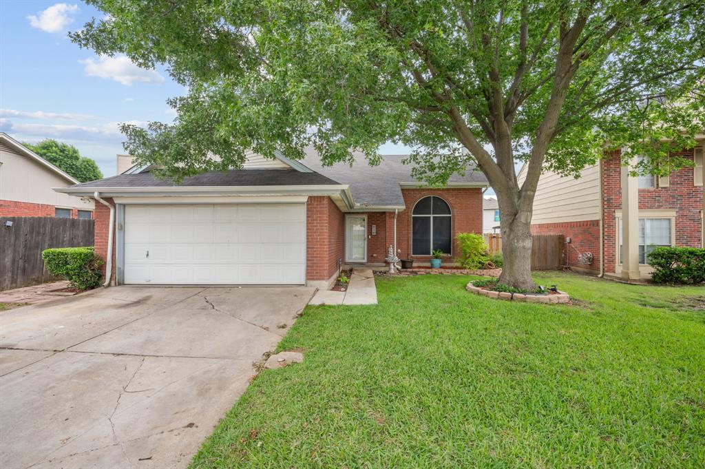 916 Danforth Place Arlington, TX 76017 - Photo 4 of 30 Brick facade residence featuring an attached two-car garage, mature front yard tree, and front entry landscaping