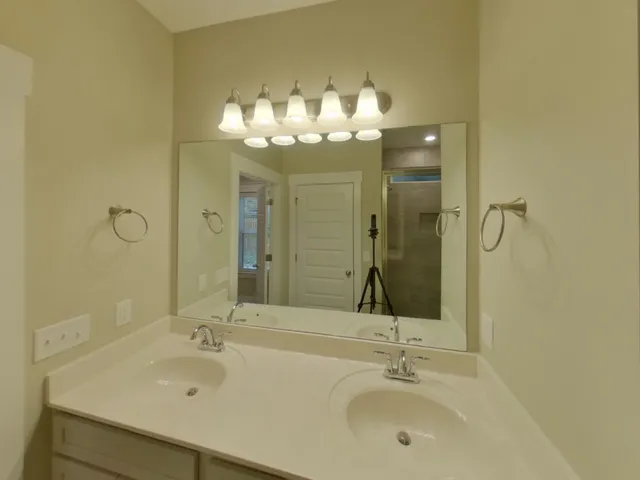 a bathroom with a sink mirror and shower