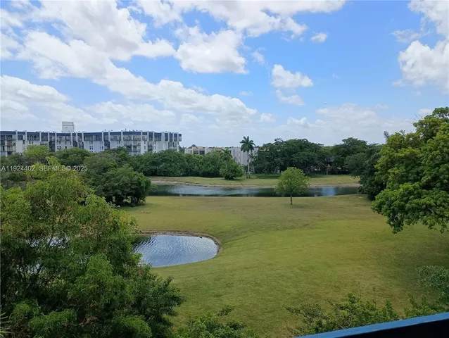 a view of a street with a cars parked on the road