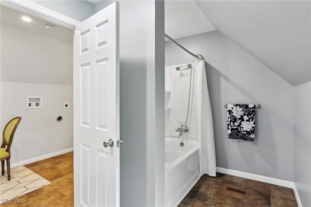 25 Taylor Road Bedford, OH 44146 - Photo 28 of 33 Full bathroom with vaulted ceiling, shower / tub combo, and baseboards