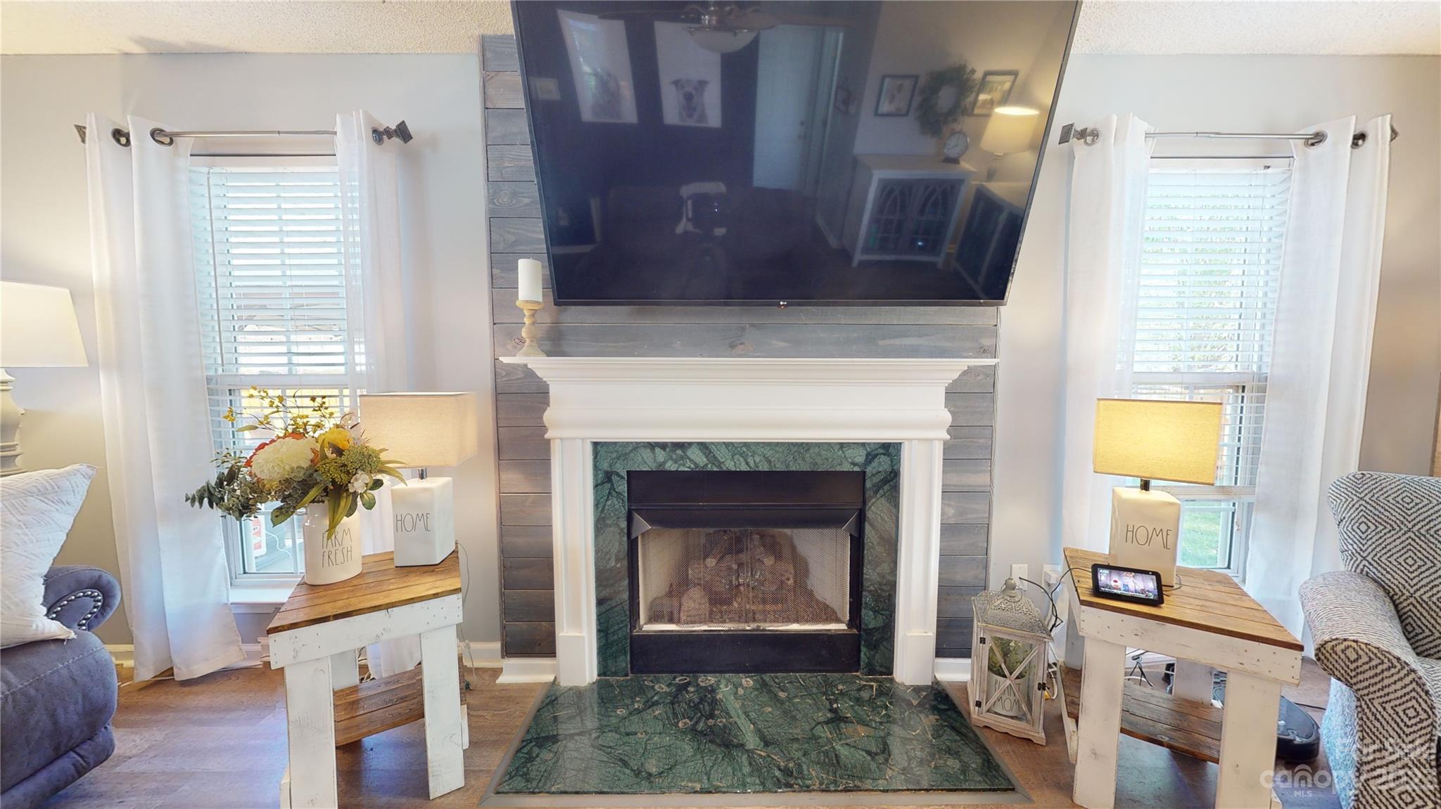 1007 Great Falls Drive Monroe, NC 28110 - Photo 14 of 45 a living room with a fireplace windows and a fireplace
