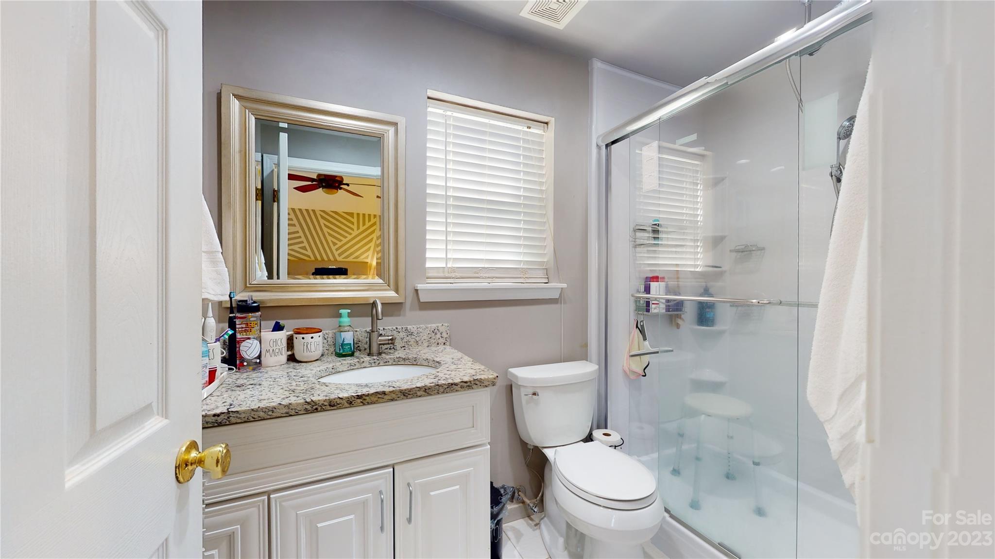 1007 Great Falls Drive Monroe, NC 28110 - Photo 25 of 45 a bathroom with a granite countertop sink toilet and shower