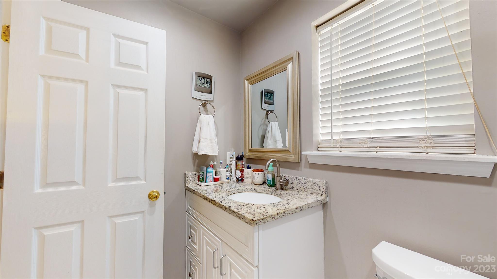 1007 Great Falls Drive Monroe, NC 28110 - Photo 26 of 45 a bathroom with a granite countertop sink and a mirror