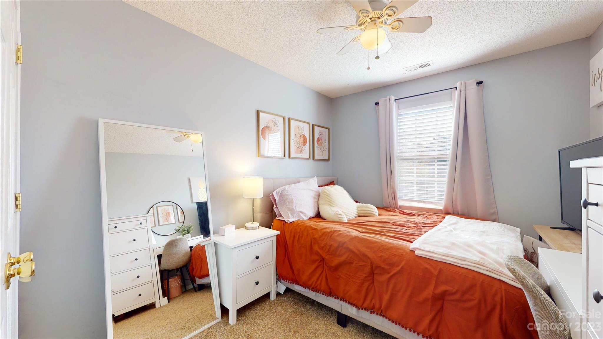 1007 Great Falls Drive Monroe, NC 28110 - Photo 28 of 45 a bedroom with a bed and a chandelier