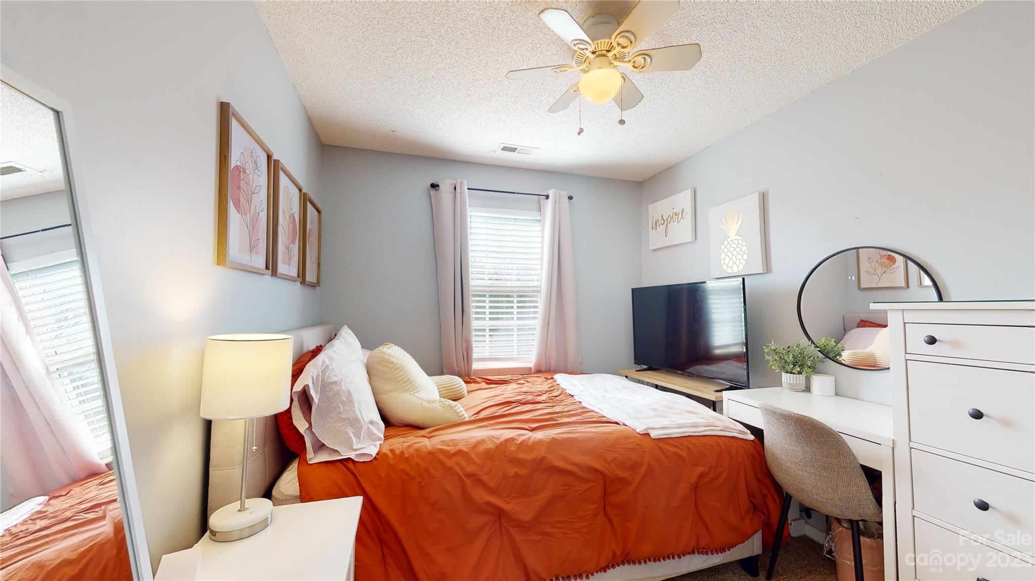 1007 Great Falls Drive Monroe, NC 28110 - Photo 29 of 45 a bedroom with a bed and a flat tv screen on the dresser