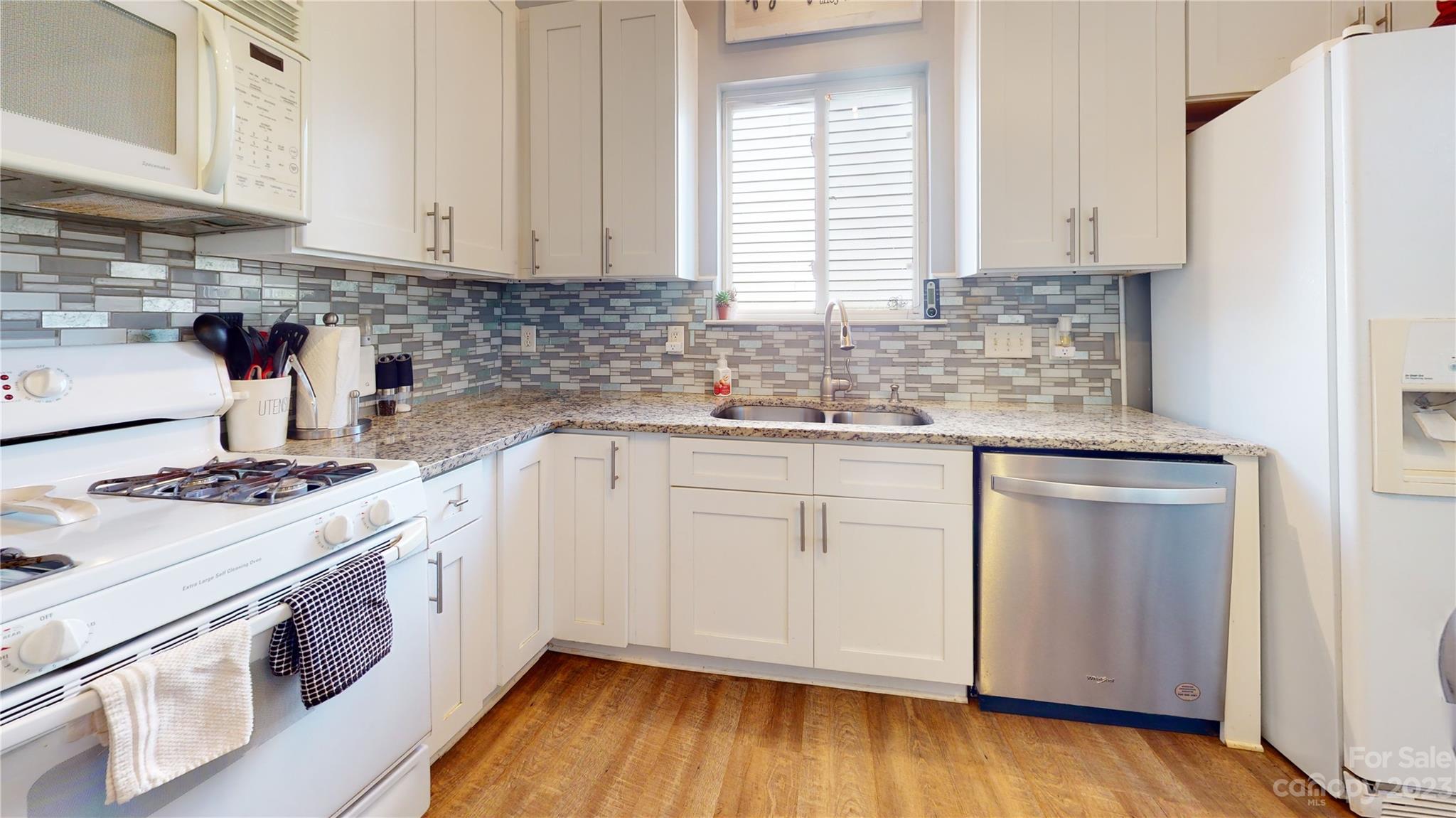1007 Great Falls Drive Monroe, NC 28110 - Photo 40 of 45 a kitchen with a sink stove and cabinets
