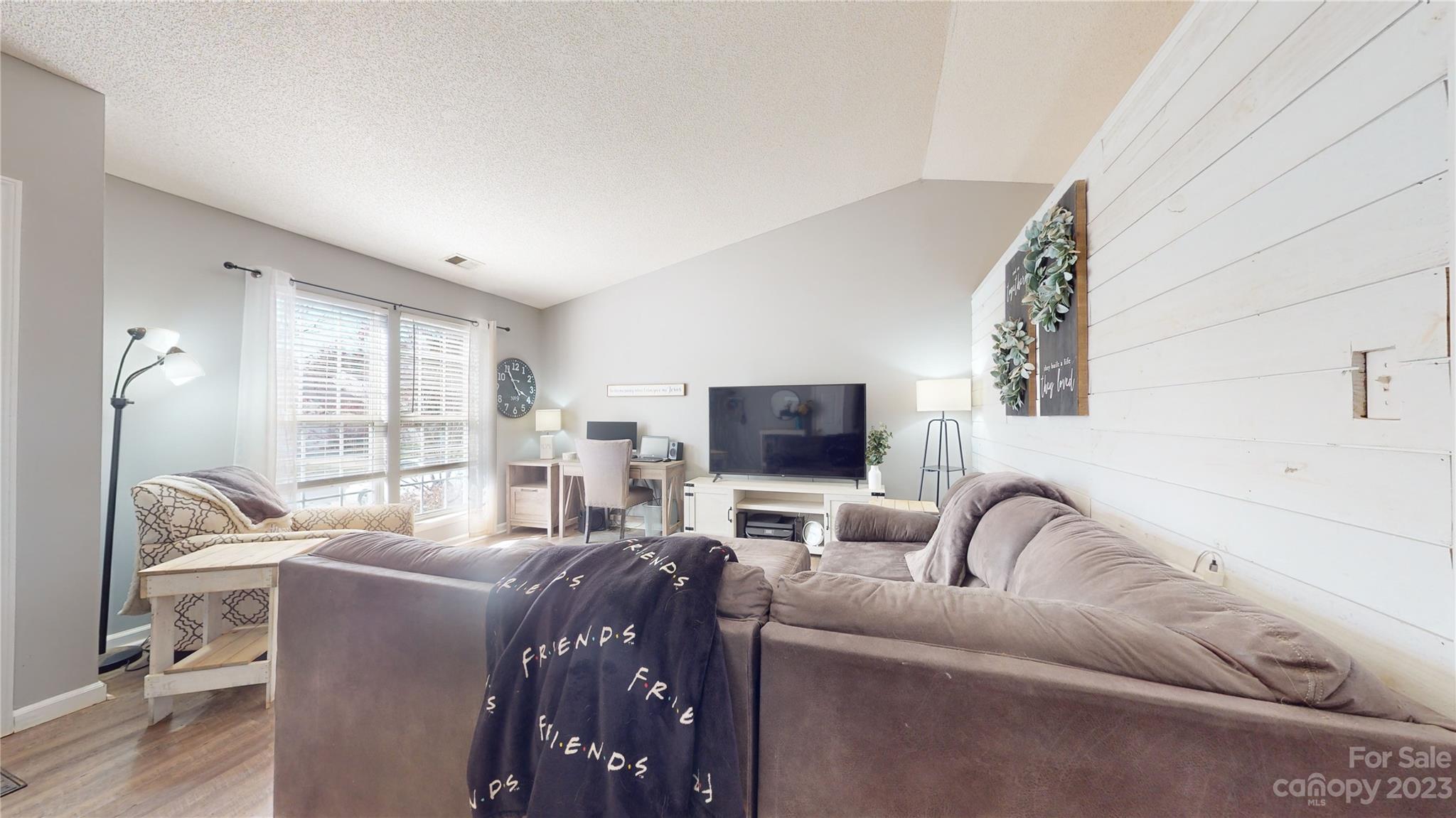 1007 Great Falls Drive Monroe, NC 28110 - Photo 5 of 45 a living room with furniture a flat screen tv and a large window