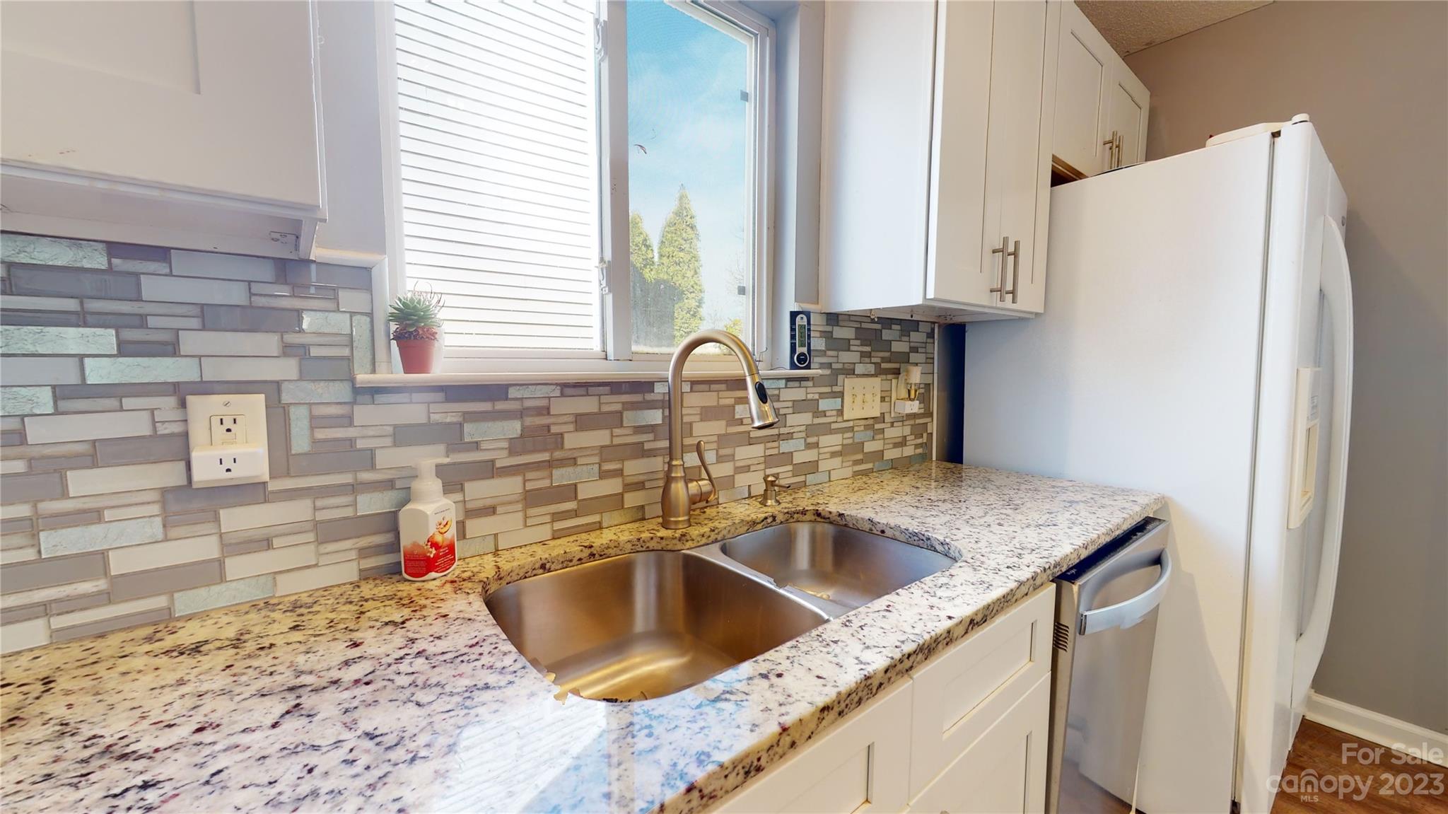 1007 Great Falls Drive Monroe, NC 28110 - Photo 8 of 45 a kitchen with granite countertop a sink and a refrigerator