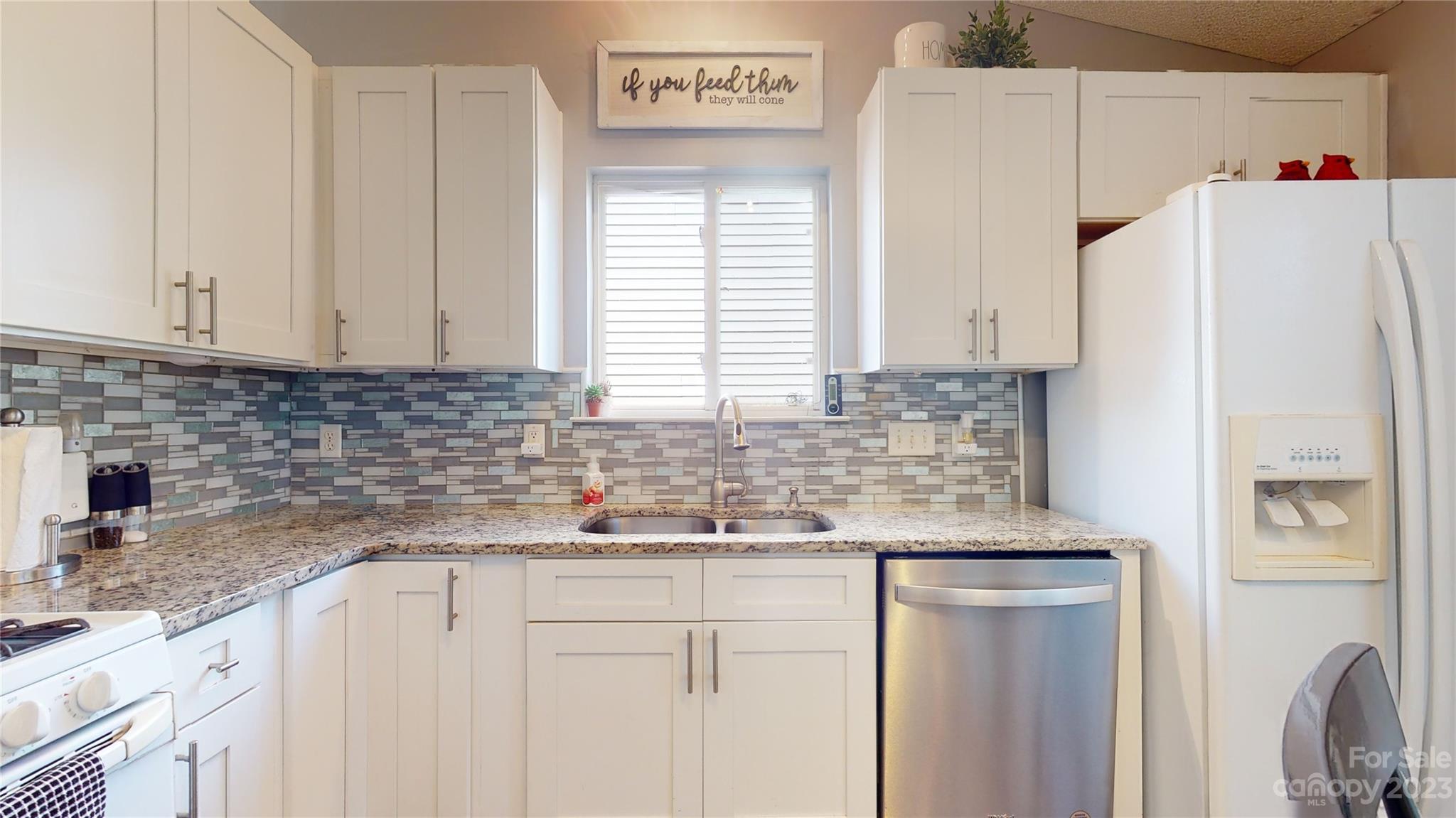 1007 Great Falls Drive Monroe, NC 28110 - Photo 10 of 45 a kitchen with stainless steel appliances granite countertop a refrigerator sink and white cabinets