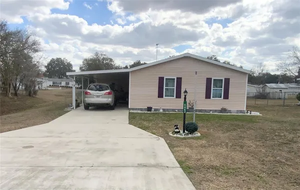 a backyard of a house with barbeque oven and barbeque oven