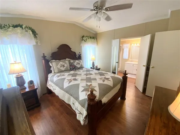 a bed sitting in a bedroom next to a window