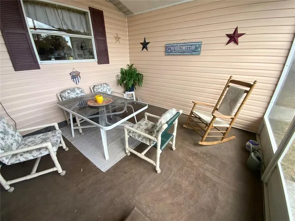 a living room with furniture flat screen tv and a large window