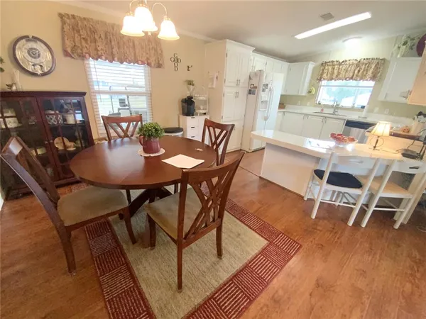 a view of a dining room with furniture and wooden floor