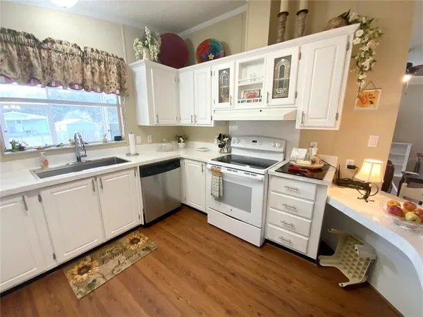 a kitchen with a sink cabinets and window