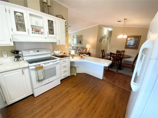 a kitchen with a stove a sink and a refrigerator