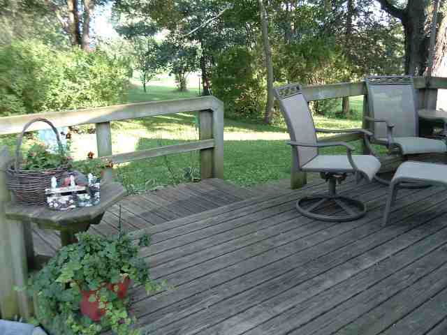 7584 East Maize Road Ridott, IL 61067 - Photo 4 of 9 a view of a chair and table in backyard of the house