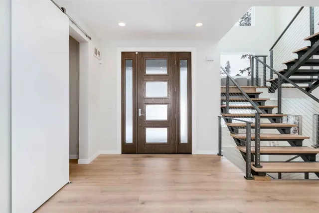 a view of an entryway with wooden floor and stairs